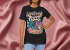 Person wearing a black t-shirt with colorful graphics and text against a pink fabric background