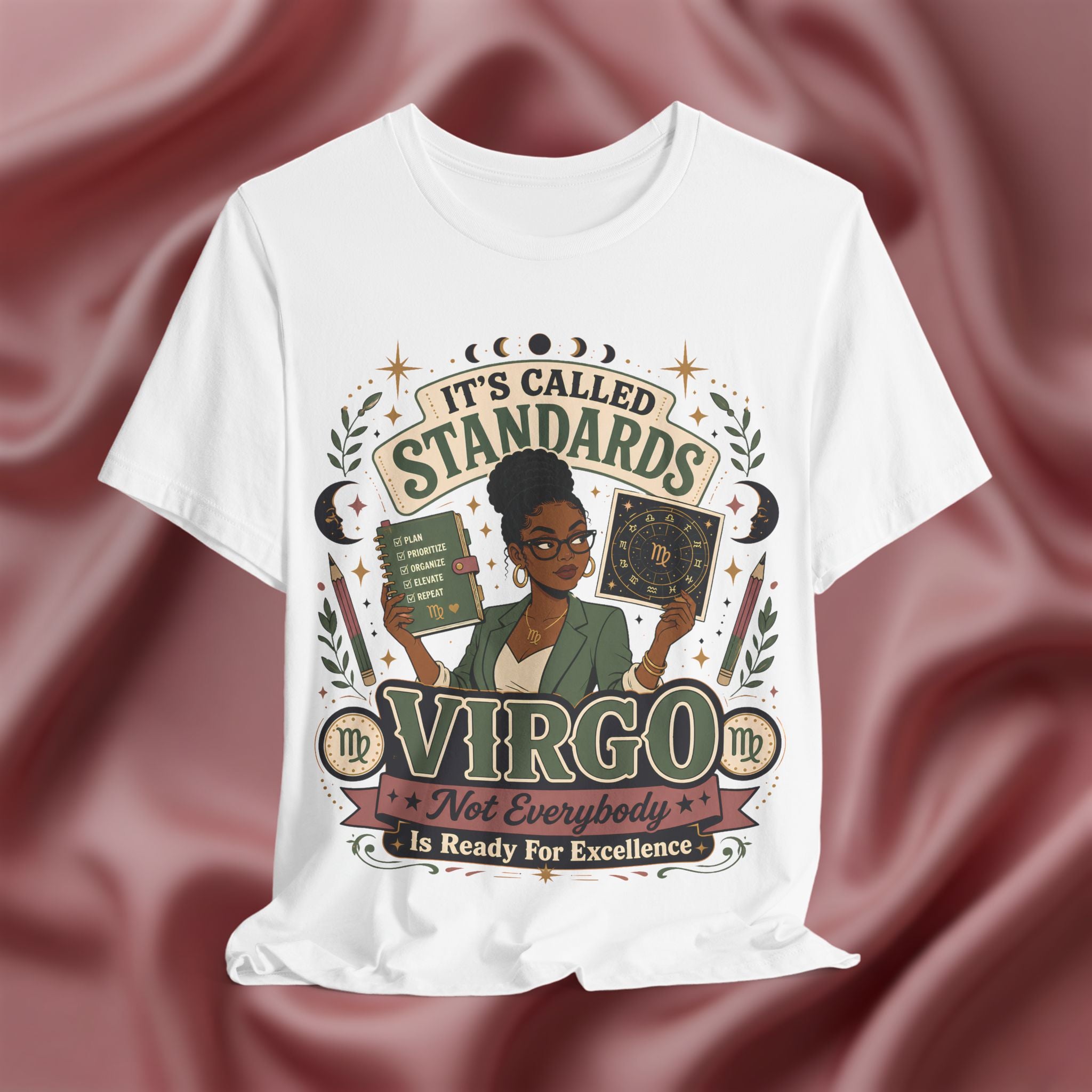 White t-shirt with Virgo zodiac design on a maroon fabric background
