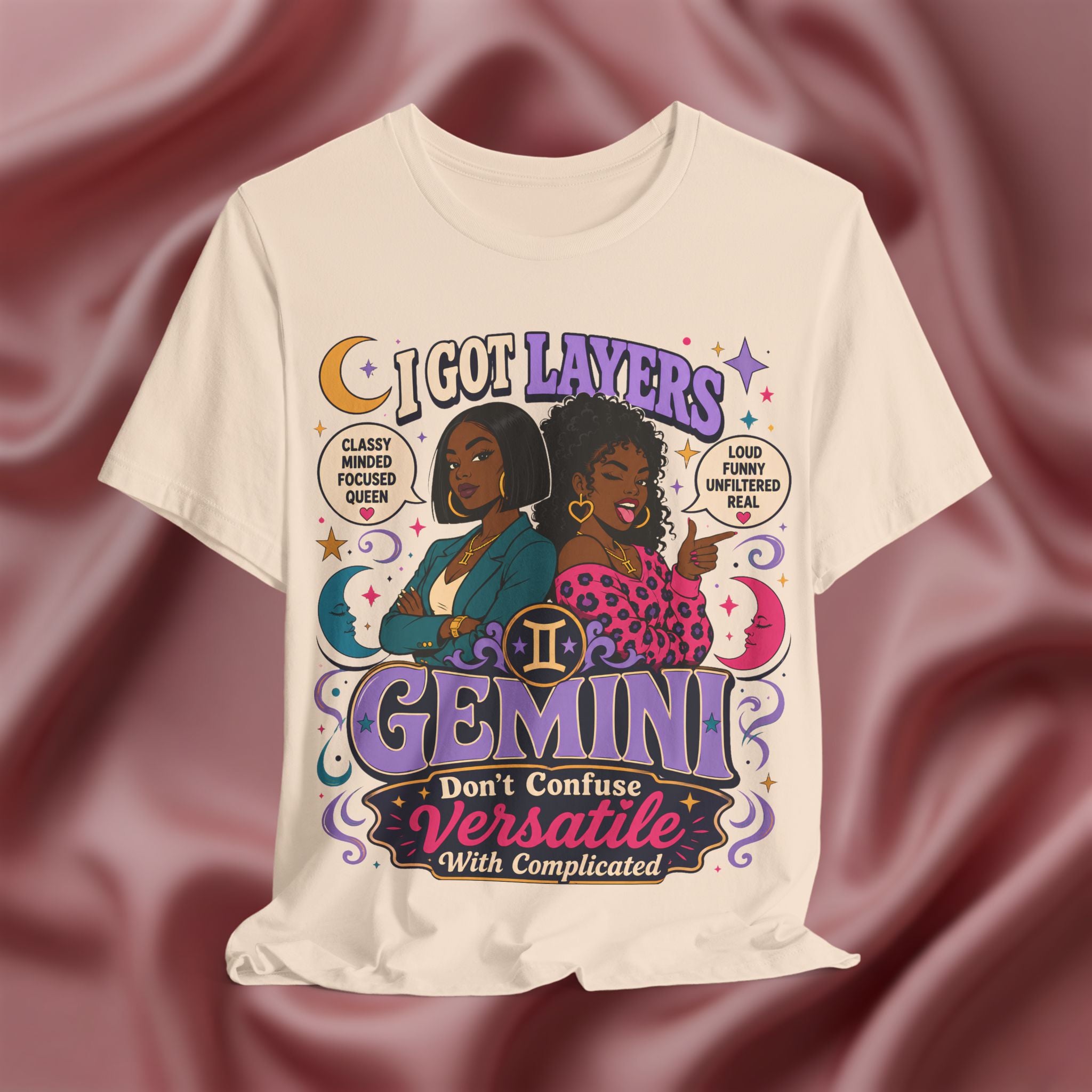 soft cream t-shirt with Gemini zodiac design featuring two women on a maroon fabric background