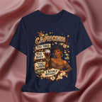 Navy blue t-shirt with Capricorn zodiac design featuring a woman and text on a pink fabric background.