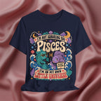 Navy blue t-shirt with colorful Pisces zodiac design on a pink fabric background