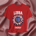 Red t-shirt with American flag sunflower and 'LIBRA ENERGY' text on a textured pink background