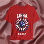 Red t-shirt with American flag sunflower and 'LIBRA ENERGY' text on a textured pink background