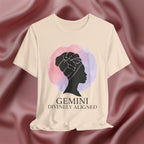 Soft cream t-shirt with a silhouette of a woman and 'Gemini Divinely Aligned' text on a pink fabric background