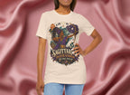 Person wearing a t-shirt with a Sagittarius design against a pink fabric background