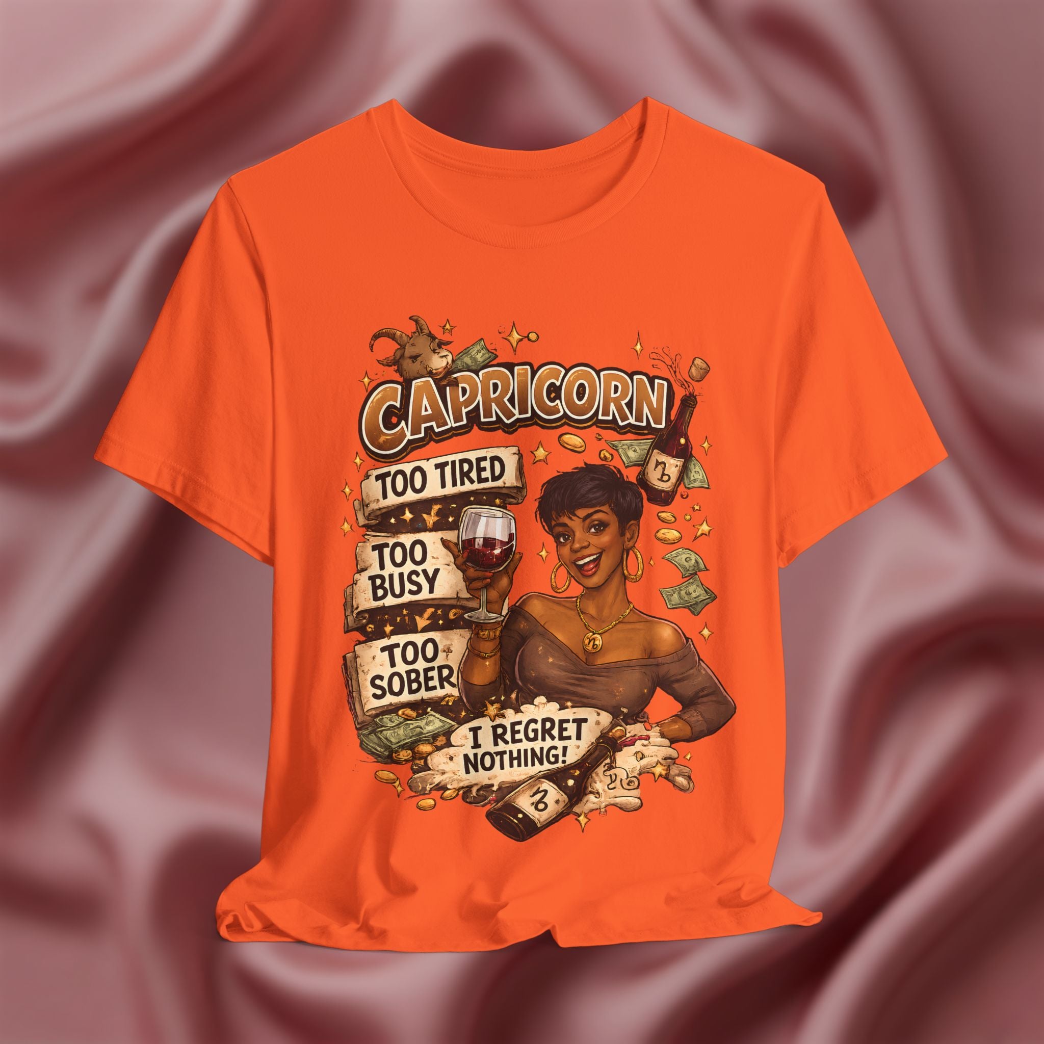 Orange t-shirt with Capricorn zodiac design on a maroon fabric background