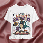 White t-shirt with Sagittarius zodiac design on a maroon fabric background