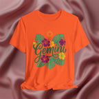 Orange t-shirt with 'Gemini' design on a textured brown background
