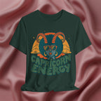 Green t-shirt with Capricorn design and 'Capricorn Energy' text on a pink fabric background