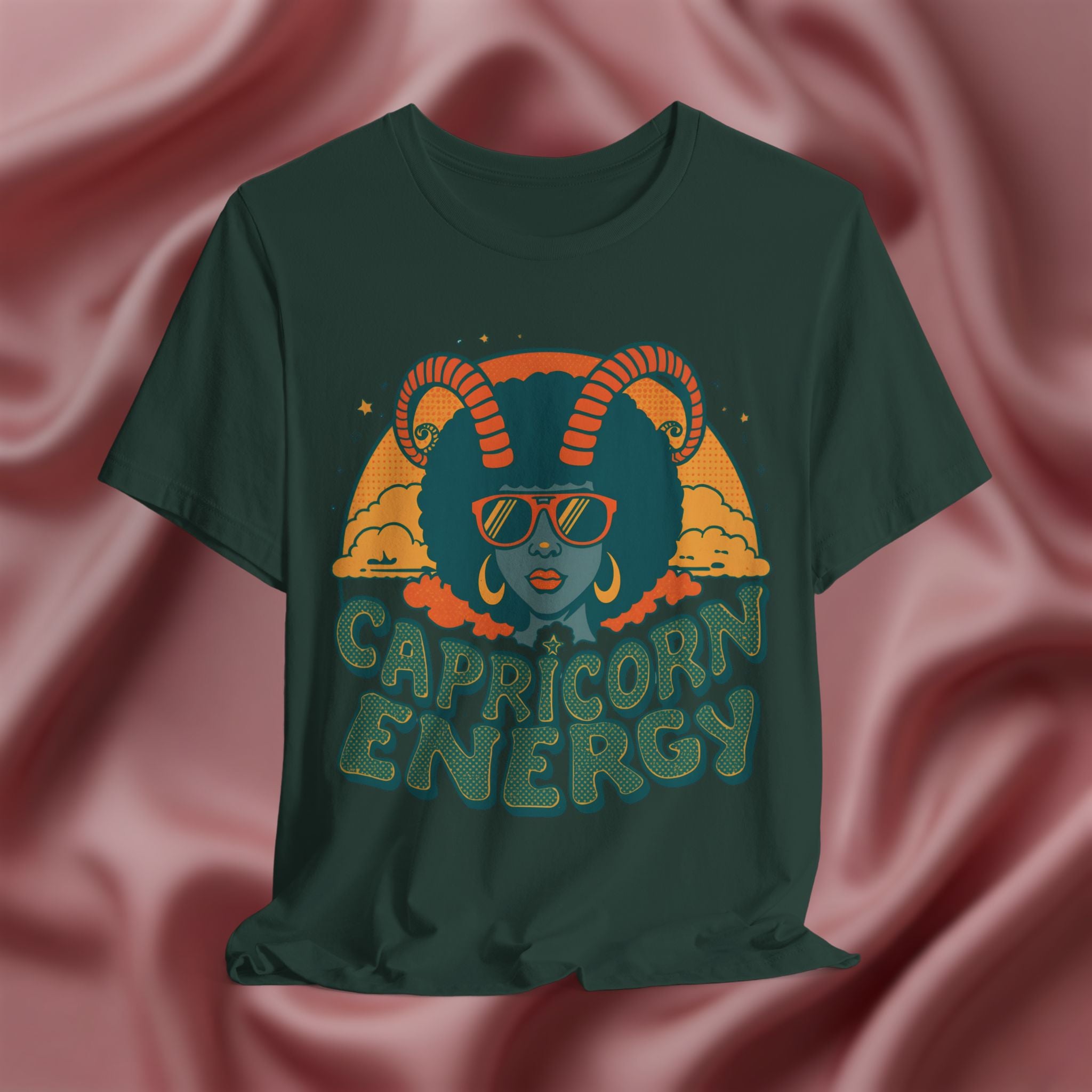 Green t-shirt with Capricorn design and 'Capricorn Energy' text on a pink fabric background