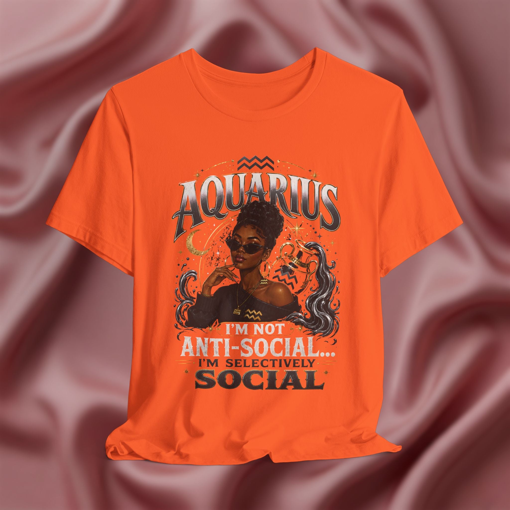 Orange t-shirt with Aquarius design featuring a black woman and text 'Aquarius I'm not anti-social I'm selectively social' on a pink fabric background