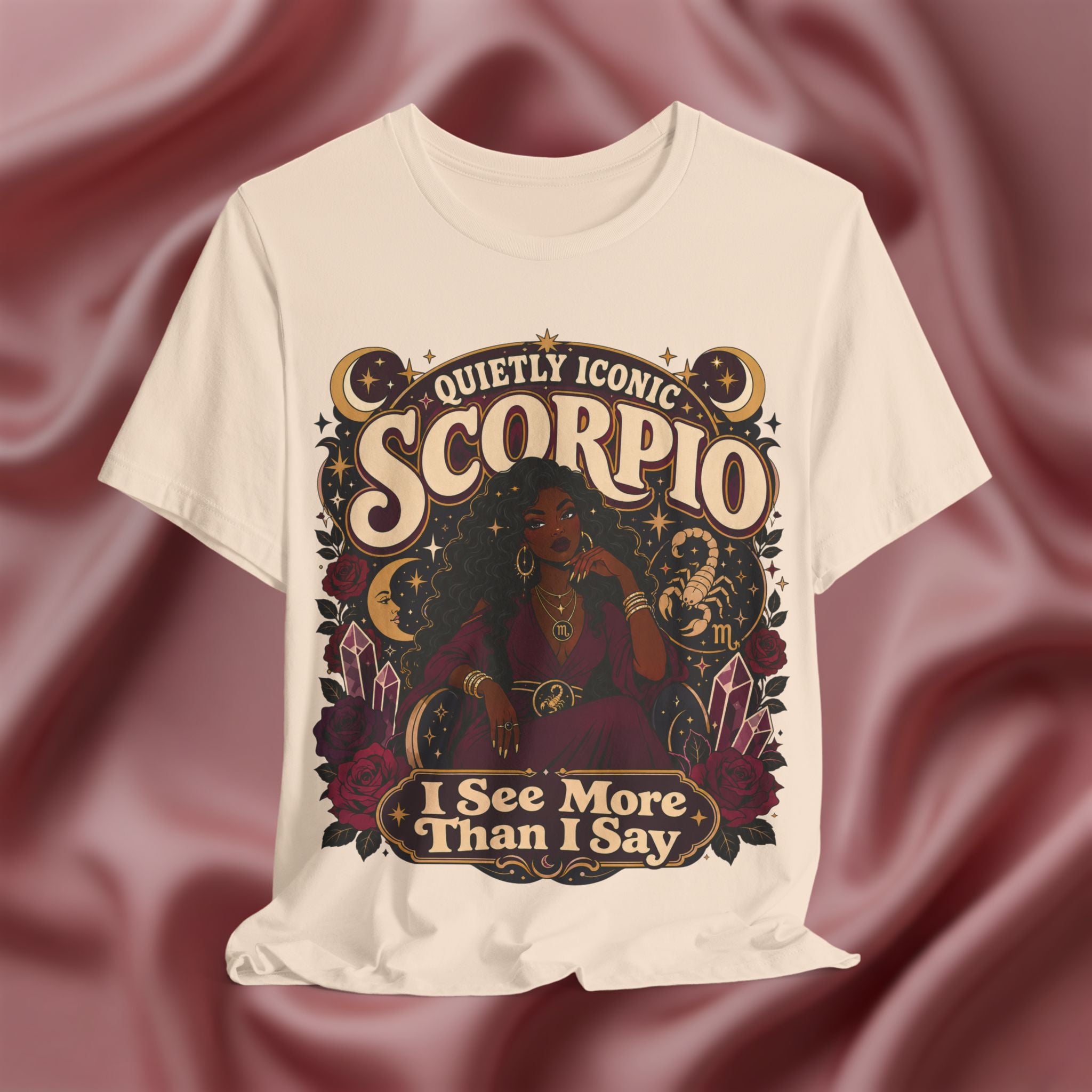 Soft cream T-shirt with Scorpio zodiac design on a maroon fabric background