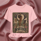 A pink crewneck t-shirt featuring a detailed vintage-style graphic of 'The Maiden Virgo' astrological card, displayed against a draped dusty rose satin background.