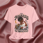 Pink t-shirt with 'Aquarius Too Weird To Care' design featuring a black woman wearing a t-shirt with the text 'different is my superpower' on a pink fabric background