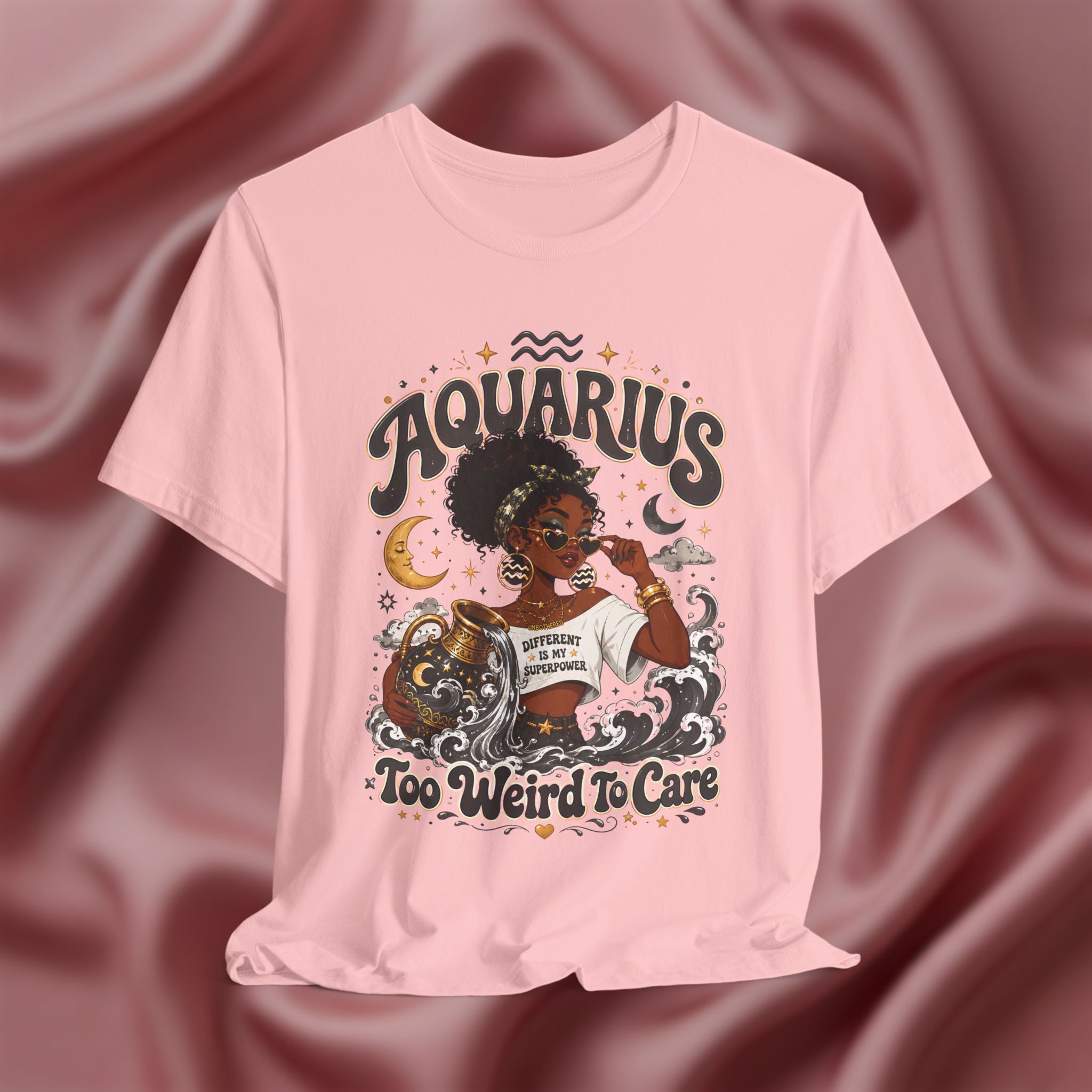 Pink t-shirt with 'Aquarius Too Weird To Care' design featuring a black woman wearing a t-shirt with the text 'different is my superpower' on a pink fabric background
