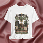 A white short-sleeve graphic t-shirt featuring a vintage-style Virgo-themed coffee design, displayed against a draped, satin-like dusty rose background.