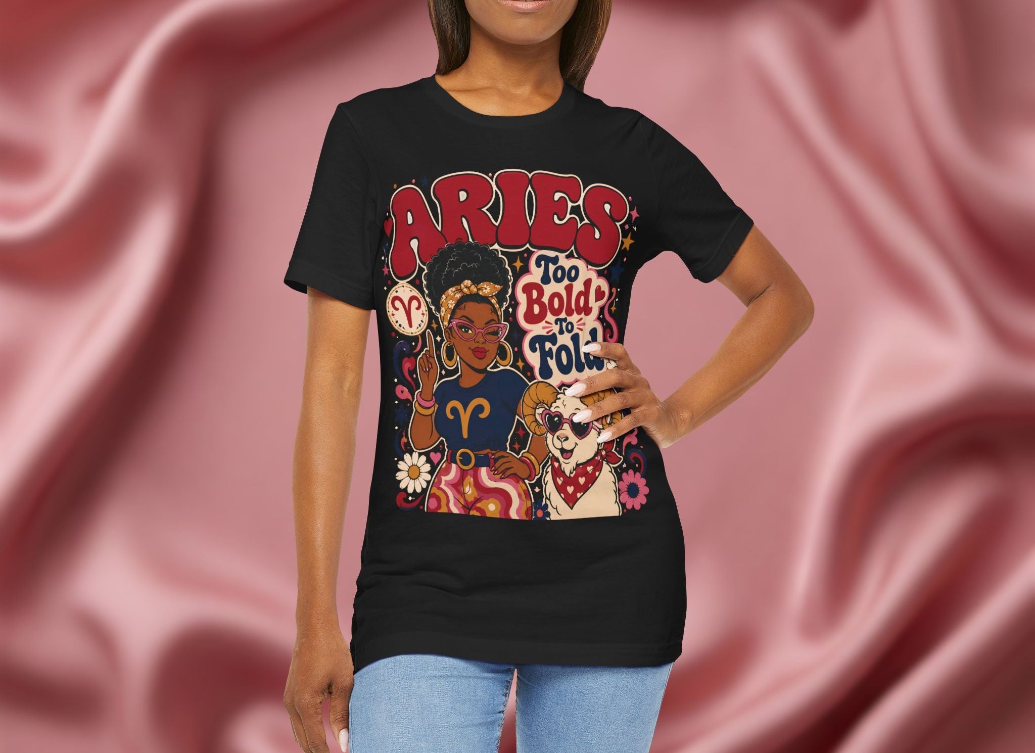 Woman wearing a black t-shirt with Aries zodiac design on a pink fabric background