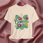 Beige t-shirt with 'Gemini' design featuring flowers and leaves on a maroon fabric background