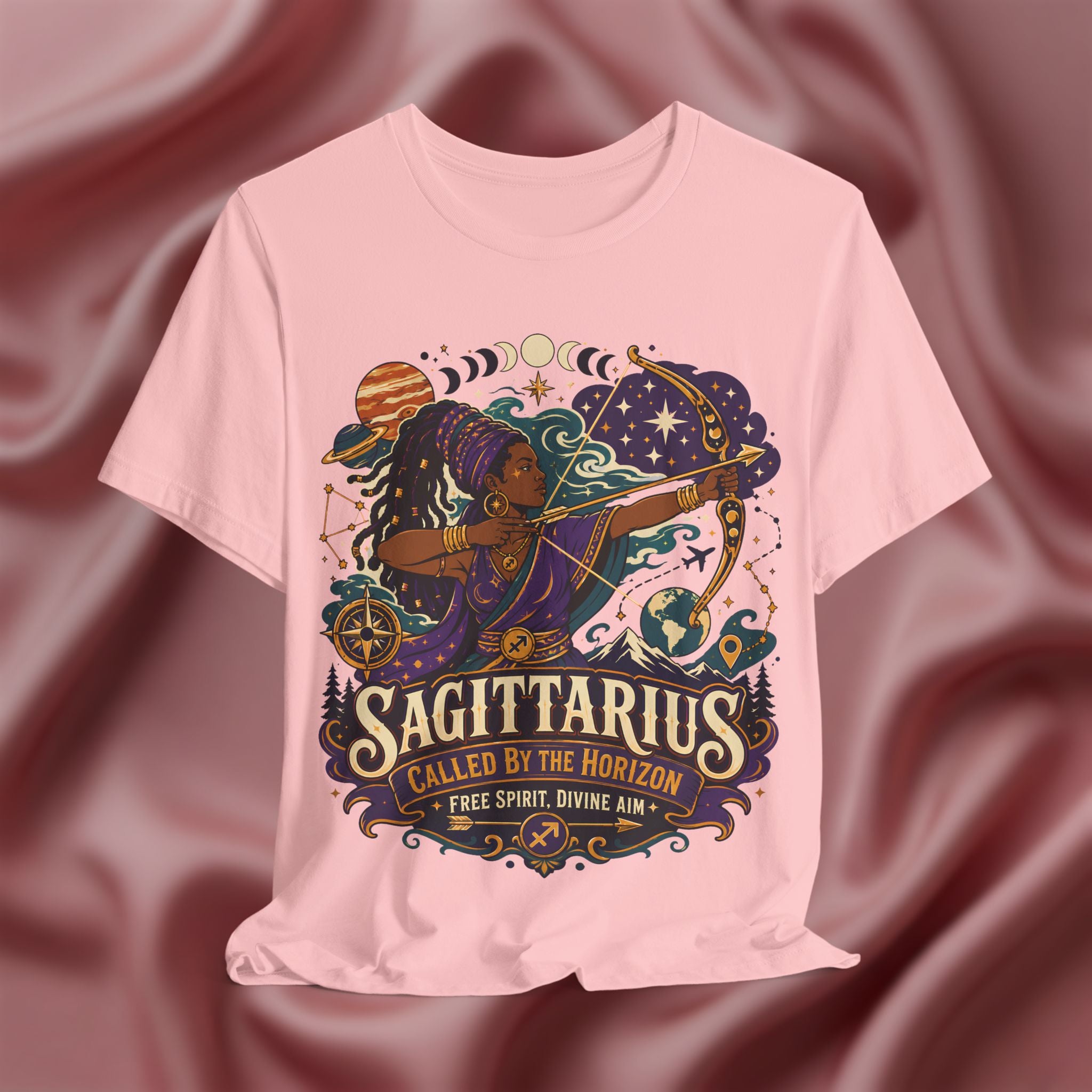 Pink t-shirt with Sagittarius zodiac design on a maroon fabric background