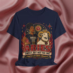 Navy blue t-shirt with Aries zodiac design on a pink fabric background