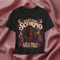 Black t-shirt with Scorpio zodiac design on a pink fabric background