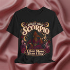 Black t-shirt with Scorpio zodiac design on a pink fabric background