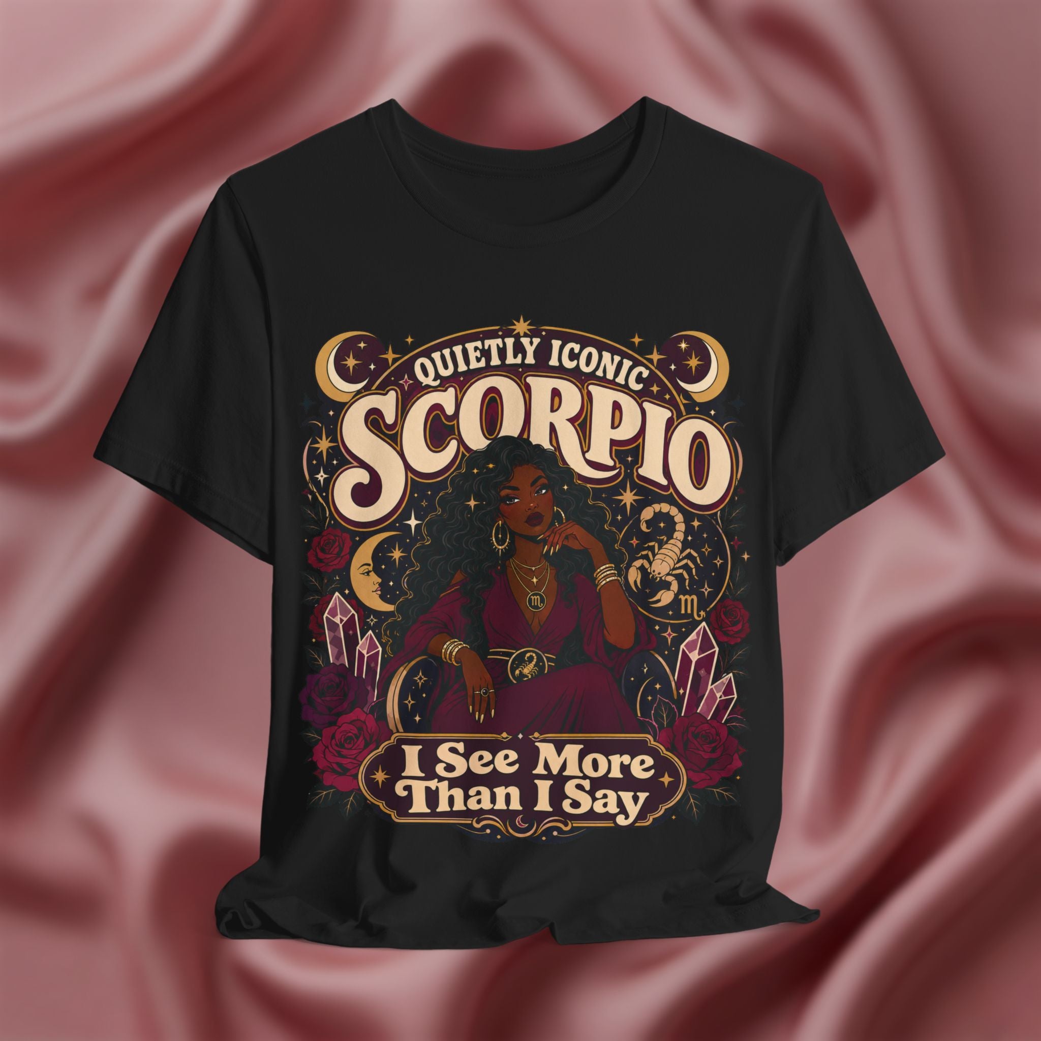 Black t-shirt with Scorpio zodiac design on a pink fabric background