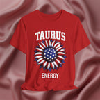 Red t-shirt with American flag sunflower and 'TAURUS ENERGY' text on a textured pink background