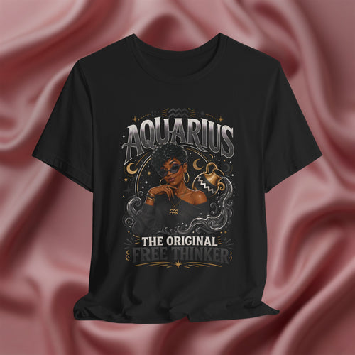 Black t-shirt with Aquarius design featuring a black woman and text 'The original free thinker' on a pink fabric background