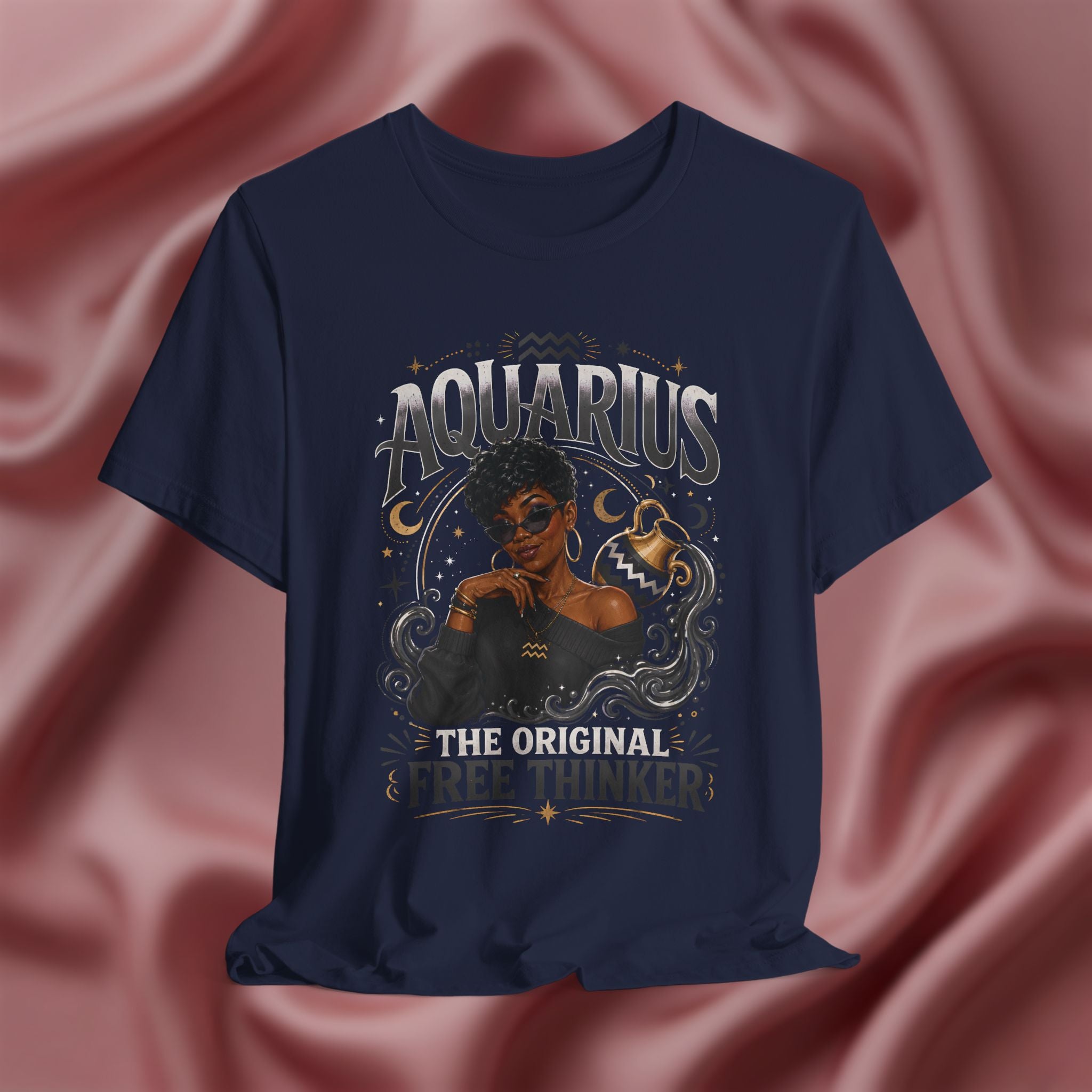 Navy blue t-shirt with Aquarius design featuring a black woman and text 'The original free thinker' on a pink fabric background