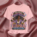 Pink t-shirt with Libra zodiac design on a maroon fabric background