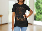Woman wearing a black t-shirt with 'Scorpio' design in a blurred indoor setting