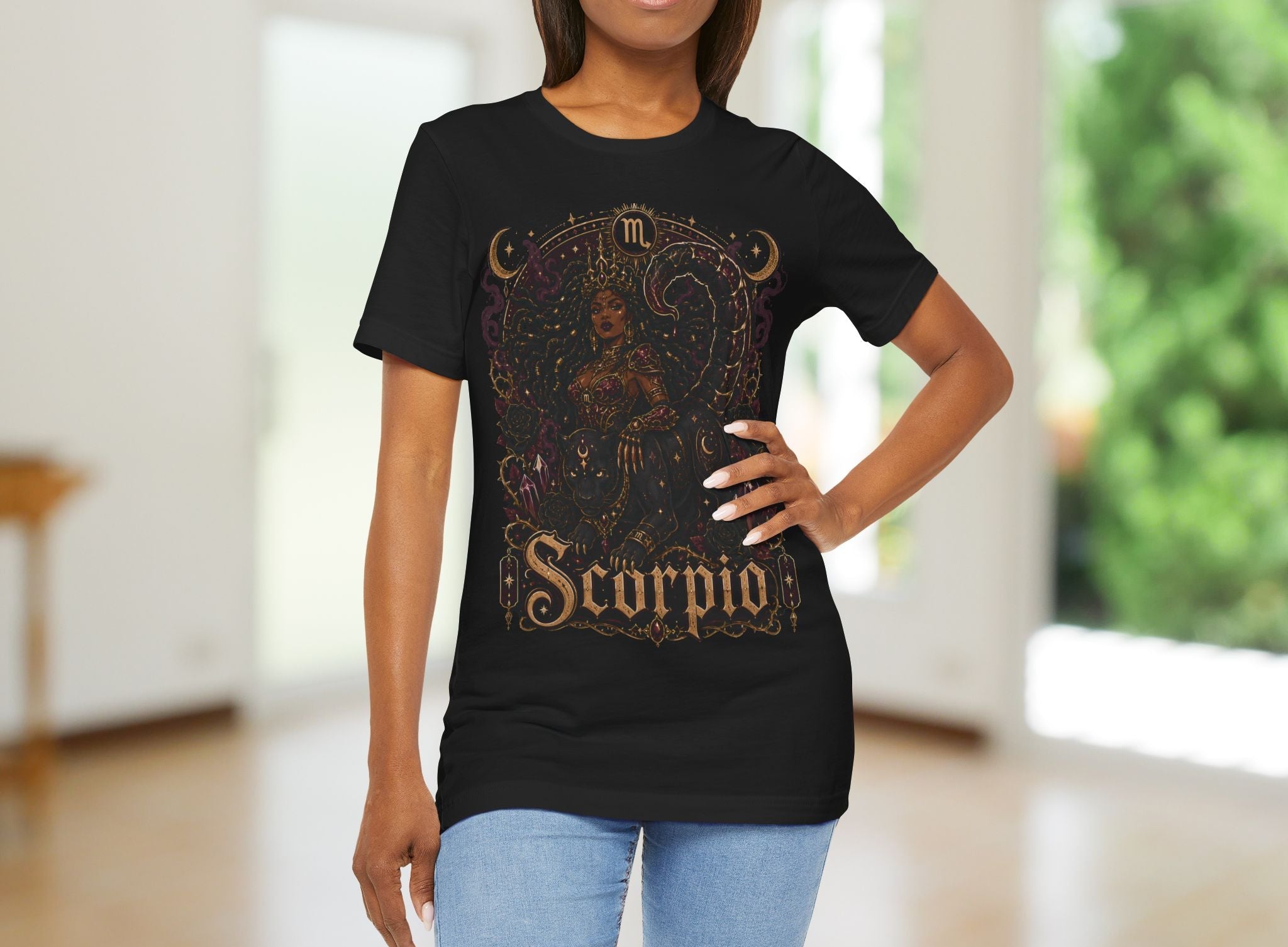 Woman wearing a black t-shirt with 'Scorpio' design in a blurred indoor setting