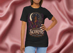 Woman wearing a black t-shirt with 'Gemini' design against a pink fabric background