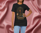 Woman wearing a black t-shirt with 'Gemini' design featuring a woman's face and roses on a pink fabric background