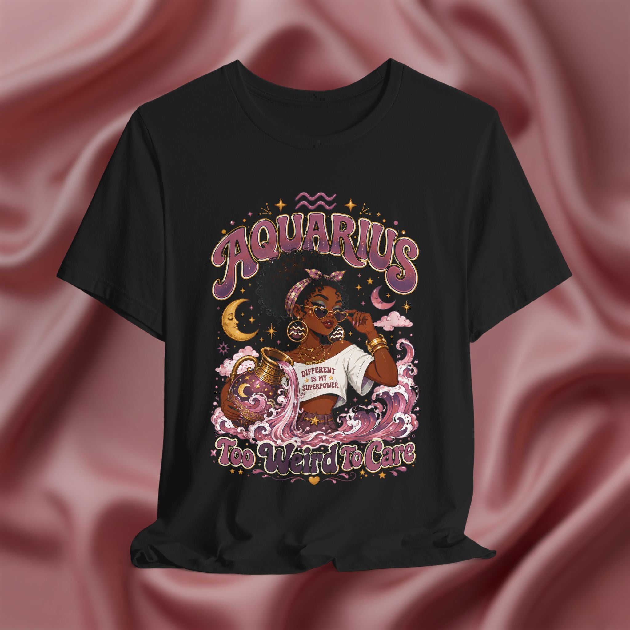 Black t-shirt with 'Aquarius Too Weird To Care' design featuring a black woman wearing a t-shirt with the text 'different is my superpower' on a pink fabric background