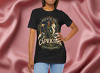 Person wearing a black t-shirt with Capricorn design on a pink fabric background