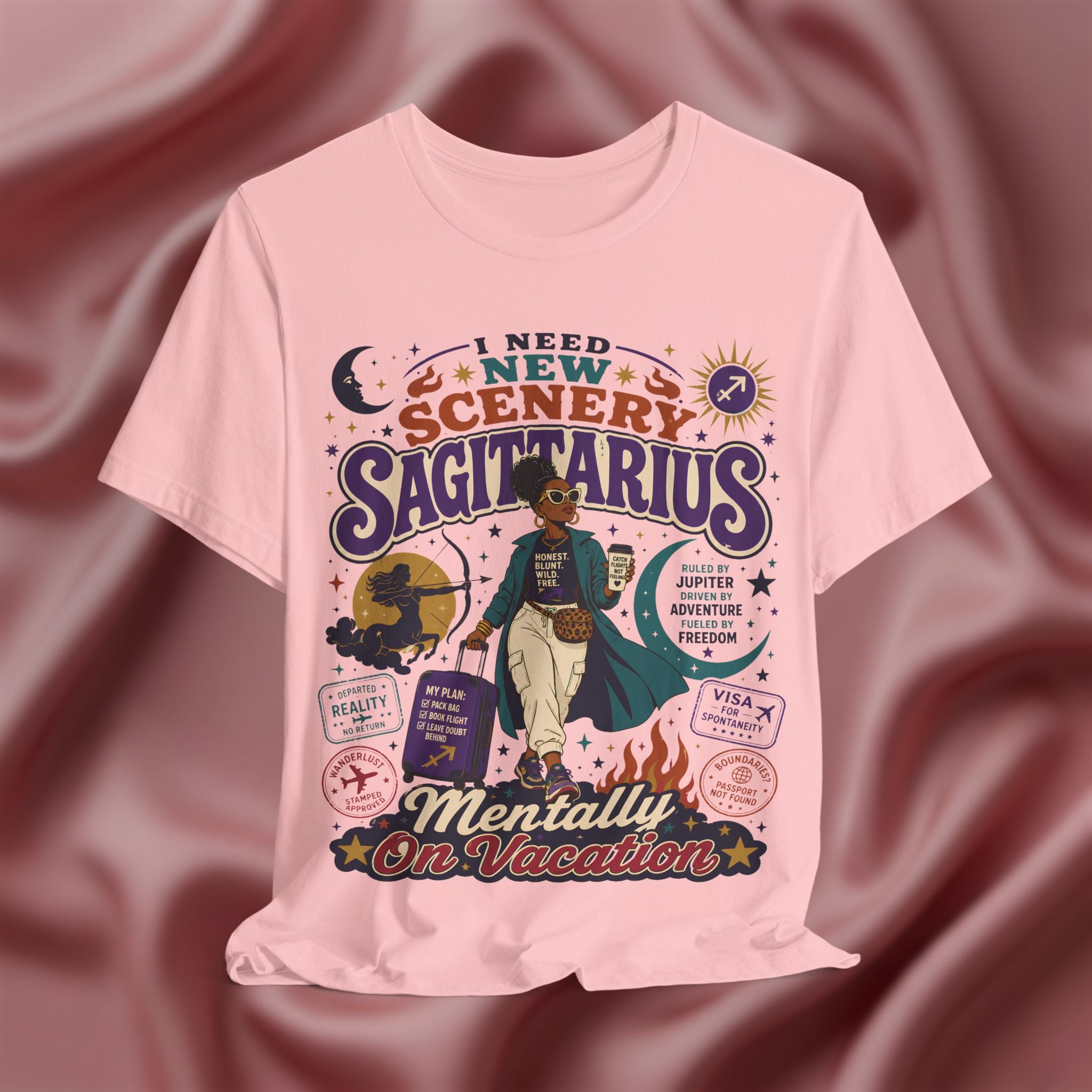 Pink t-shirt with Sagittarius zodiac design on a maroon fabric background