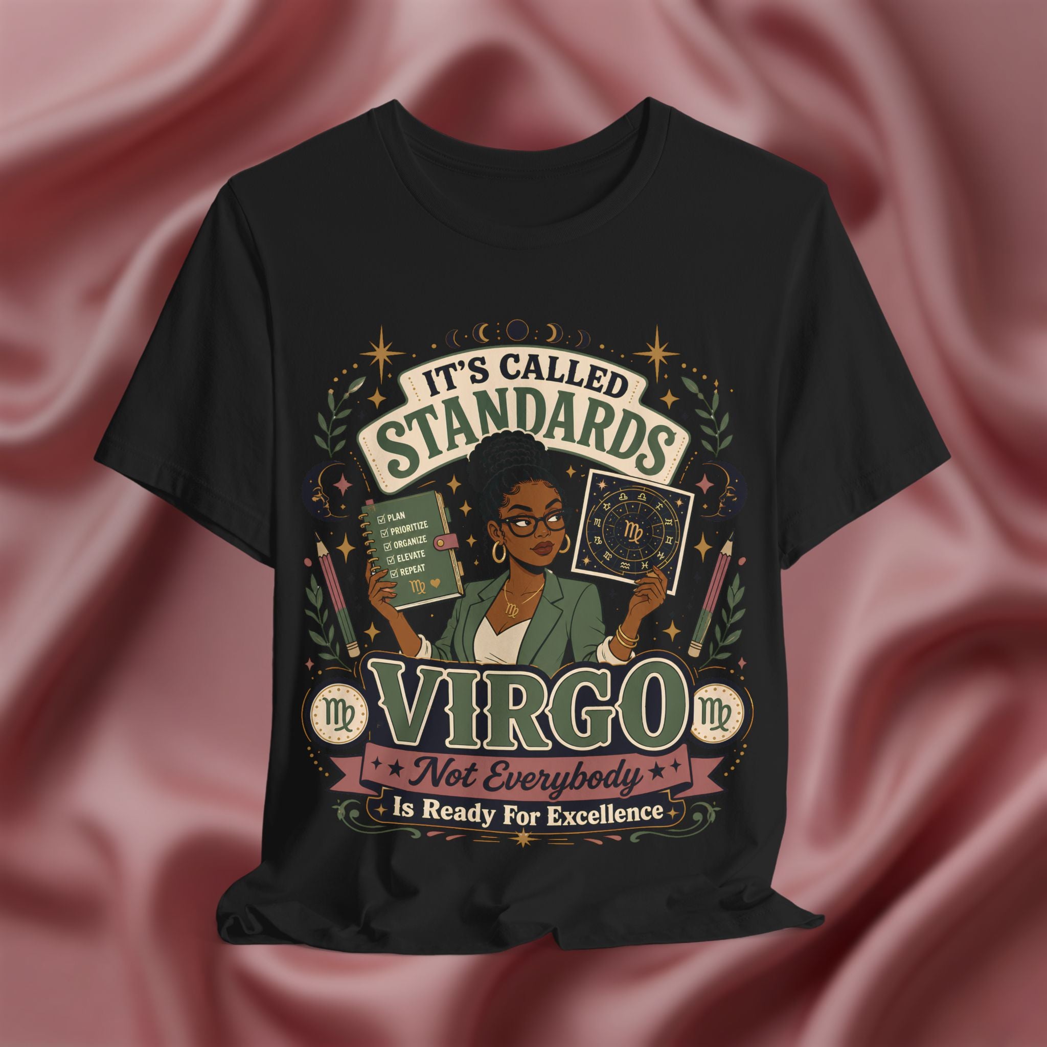 Black t-shirt with Virgo zodiac design on a pink fabric background