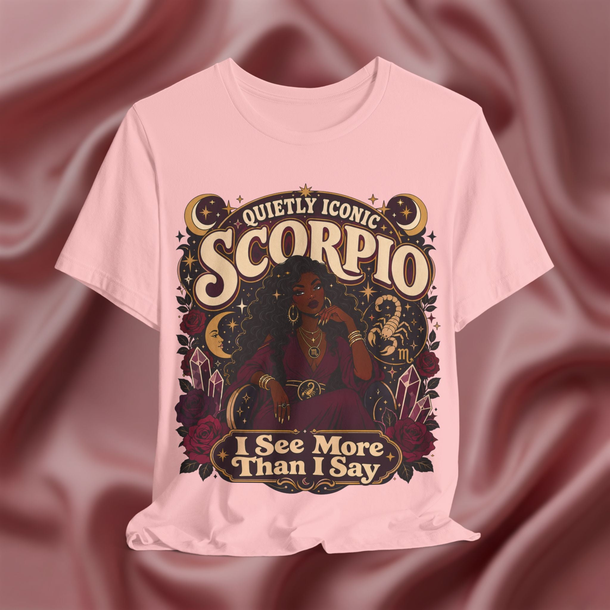 Pink t-shirt with Scorpio zodiac design on a maroon fabric background