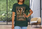 A woman modeling a dark green graphic t-shirt with a vintage-style 'The Maiden Virgo' celestial print, standing in a modern room with large windows and a chair.