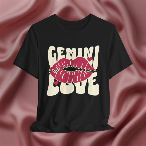 Black t-shirt with 'GEMINI Love' and lips design on a pink fabric background