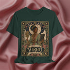A dark green short-sleeve t-shirt featuring an Art Nouveau style 'The Maiden Virgo' graphic print, displayed against a draped pink satin fabric background.