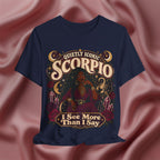 Navy blue t-shirt with Scorpio zodiac design on a pink fabric background
