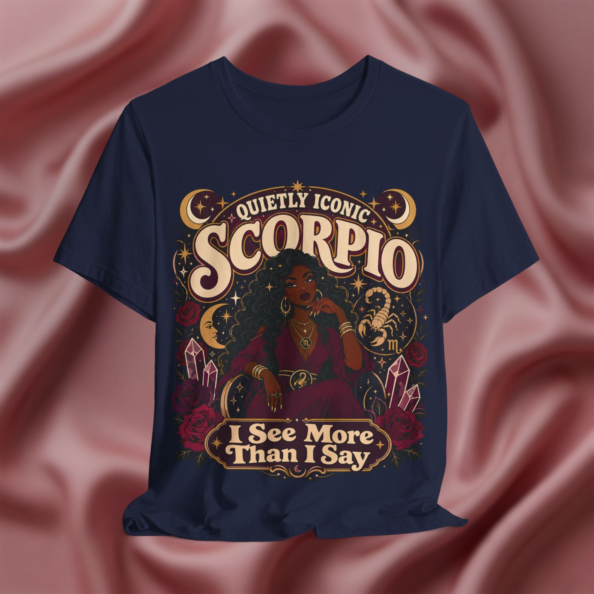 Navy blue t-shirt with Scorpio zodiac design on a pink fabric background