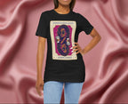 Sophisticated Queen Gemini Energy Woman wearing a black t-shirt with a graphic design on a pink fabric background