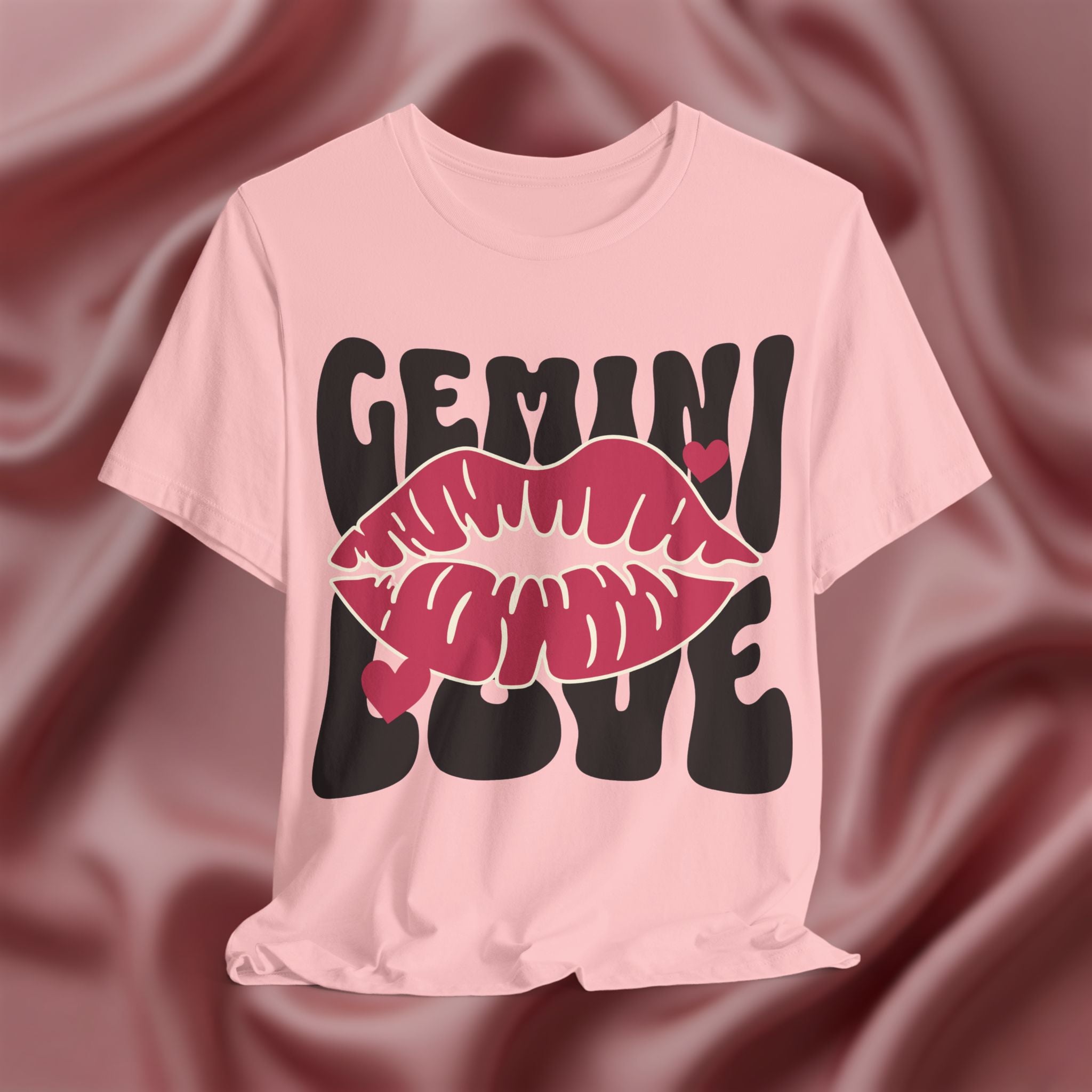Pink t-shirt with 'GEMINI LOVE' design on a textured pink background