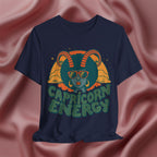 Navy blue t-shirt with Capricorn design and 'Capricorn Energy' text on a pink fabric background