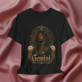 Black t-shirt with Taurus zodiac design on a pink fabric background