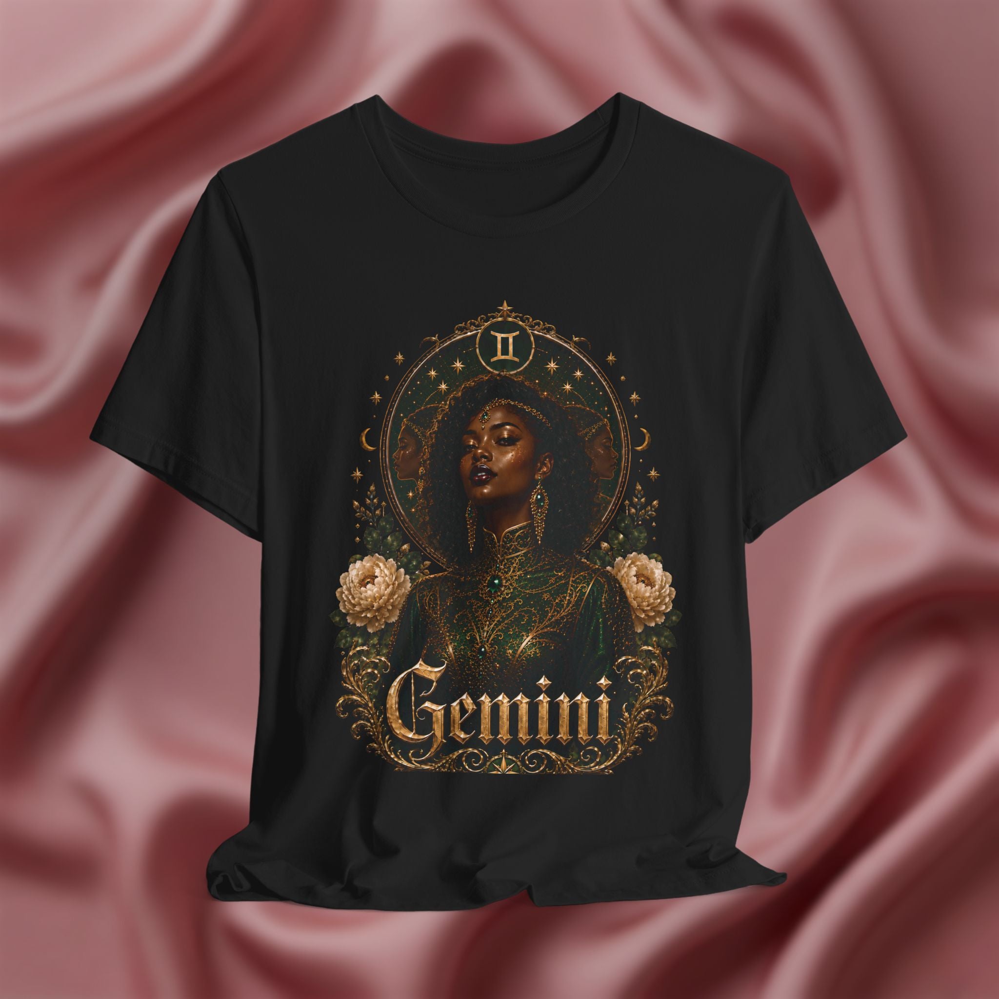 Black t-shirt with Taurus zodiac design on a pink fabric background